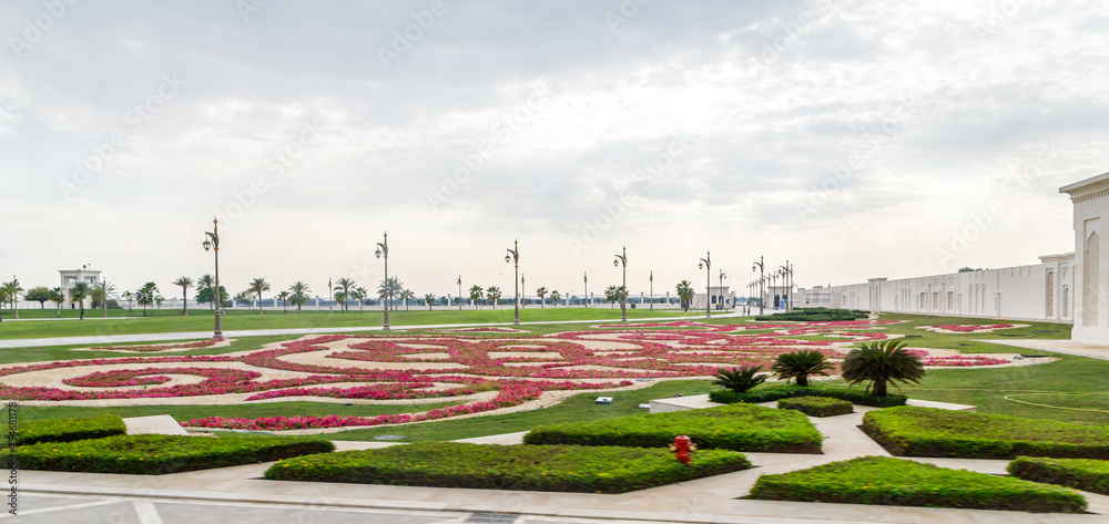 Obraz premium View from the window of a tourist bus on the ornamental garden adjoining to the presidential palace - Qasr Al Watan in Abu Dhabi city, United Arab Emirates
