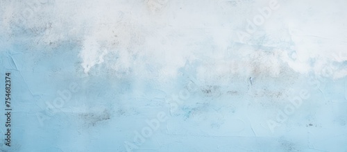 This painting showcases a textured blue and white wall with a mix of pastel blue and light concrete. The wall appears modern and vintage, with a soft, scratched sand grunge finish. The paintbrush