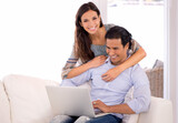 Portrait, smile and couple on sofa with laptop for internet, browse and search for movie subscription. Relax, happy woman and man on couch together on app for online streaming, love and entertainment