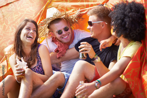 Happy friends, laughing and camping in tent for funny joke, comedy or humor at outdoor festival. Friendship, young group or people smile enjoying fun holiday, drinks or event for bonding on campsite