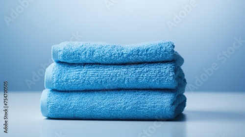 Blue cotton towels on a blue background. Bathroom decor and accessories.