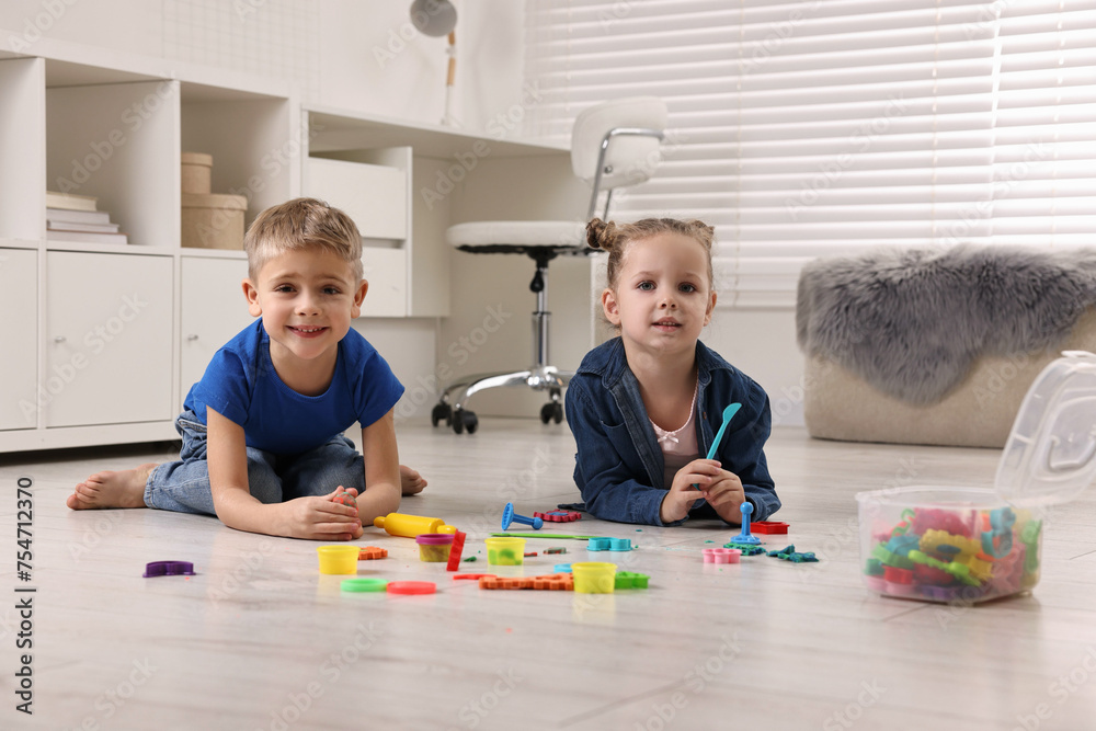 Cute little children playing on warm floor at home. Heating system Cute little children playing on warm floor at home. Heating system