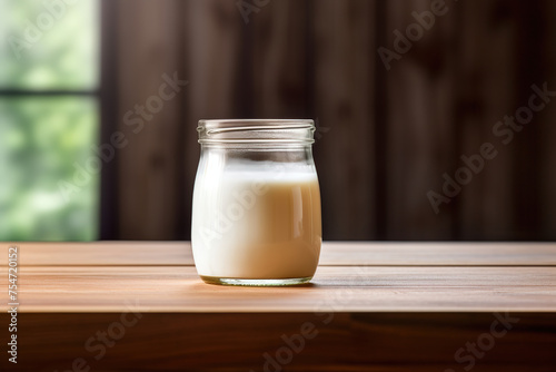 homemade yoghurt in a glass jar on a wooden table
