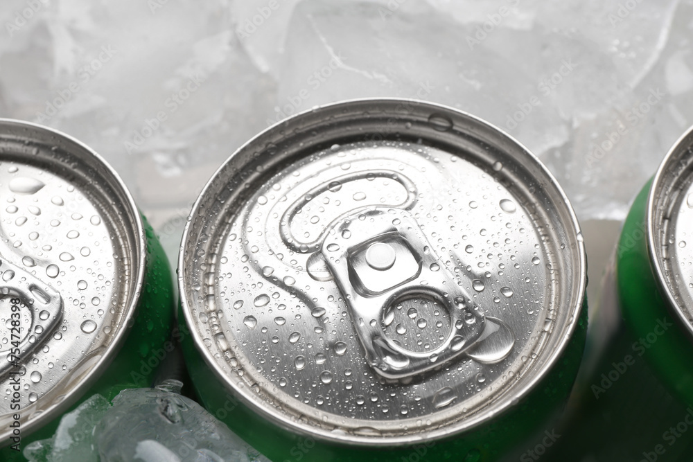 Energy drinks in wet cans and ice cubes, closeup Energy drinks in wet cans and ice cubes, closeup