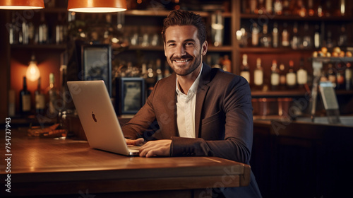 handsome businessman with a laptop at the counter bar 
