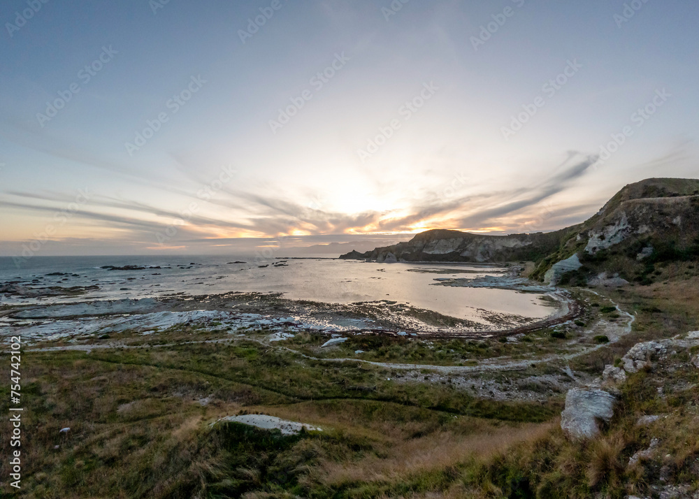 Golden Sunset Serenity: Kaikoura Coastal Walkway Landscape with clifftop views of the sea and mountains, South Island, New Zealand