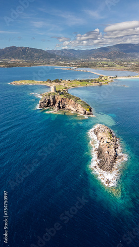 Panorama of the coast of Pula in Sardinia. Crystal clear sea and clouds in the distance