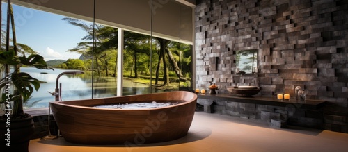 A spacious bathroom contains a luxurious large bathtub positioned next to a window  offering a view of the outside. The bathtub is designed in a contemporary style  perfect for relaxation and comfort.