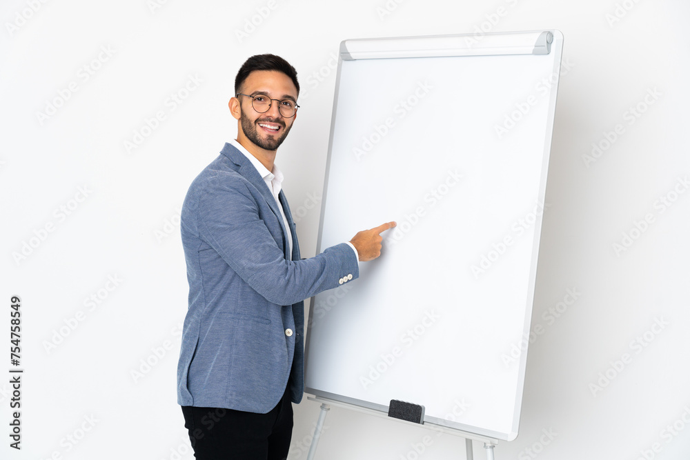 Young caucasian man isolated on white background giving a presentation on white board Young caucasian man isolated on white background giving a presentation on white board