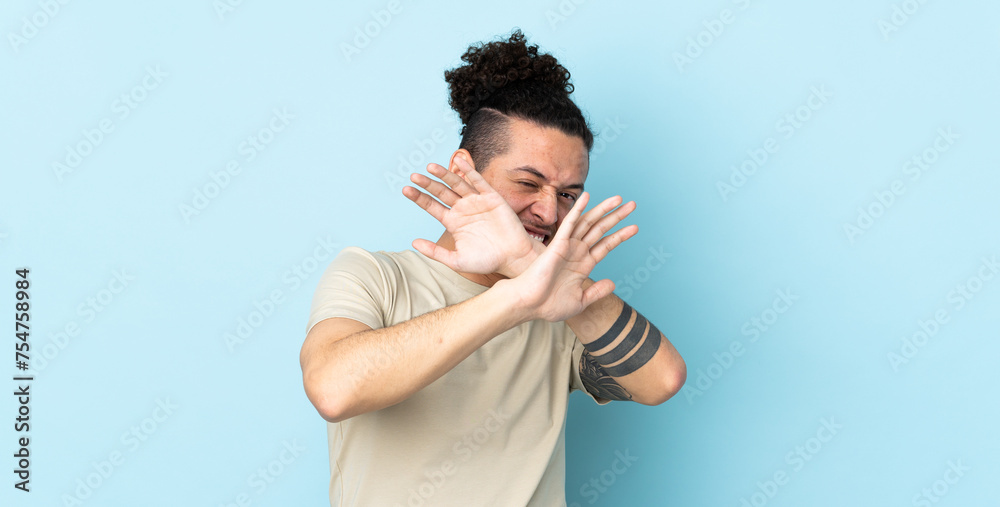 Caucasian man over isolated background nervous stretching hands to the front Caucasian man over isolated background nervous stretching hands to the front