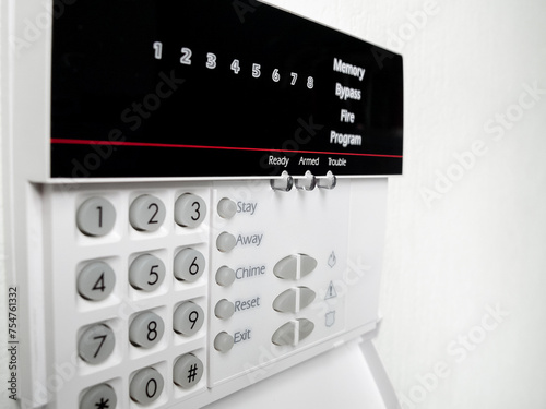 Fotografie alarm control panel on the light wall of the room, Isolated