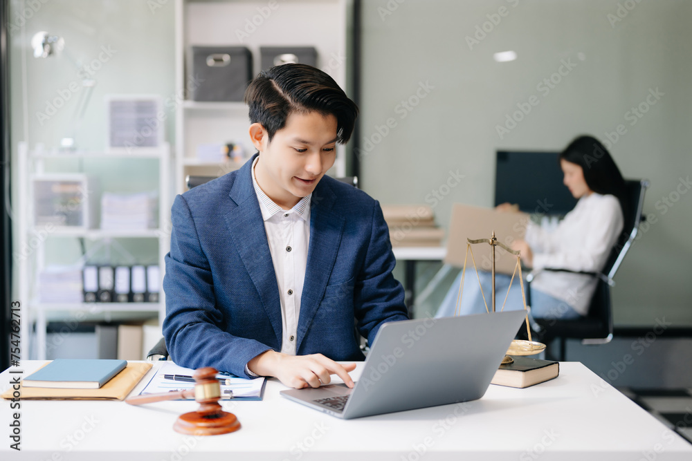 Asian man lawyer working and gavel, tablet, laptop in front, Advice justice and law concept... Asian man lawyer working and gavel, tablet, laptop in front, Advice justice and law concept...