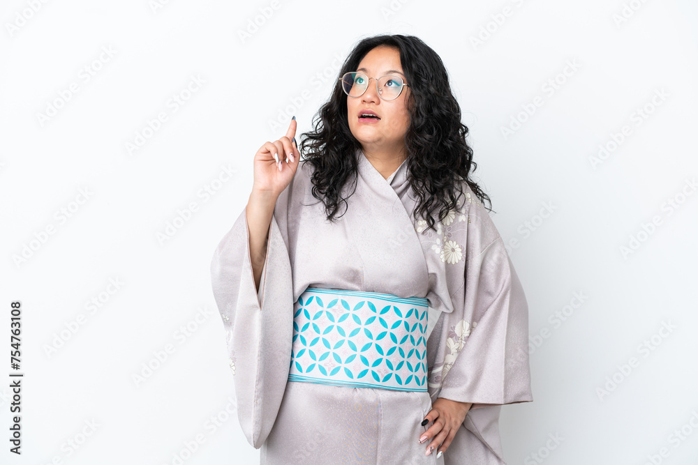 Young asian woman wearing kimono isolated on white background thinking an idea pointing the finger up