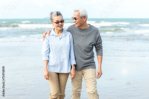 Asian Lifestyle senior couple hug on the beach happy in love romantic and relax time.  People tourism elderly family travel leisure and activity after retirement in vacations and summer.
