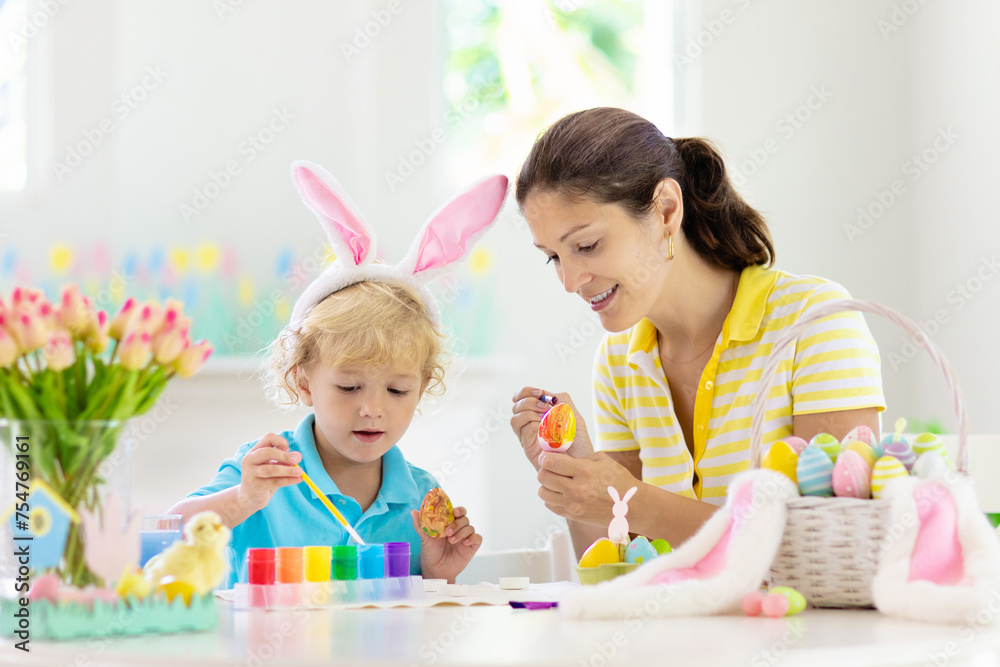 Mother and kids, family coloring Easter eggs. Mother and kids, family coloring Easter eggs.