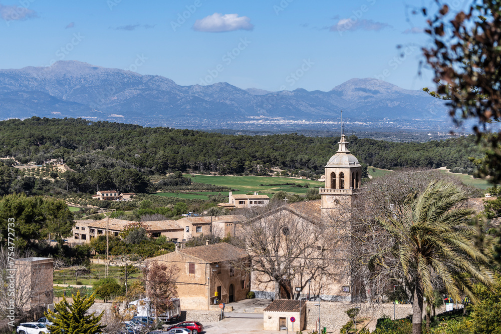 town of Randa, parish church of the Immaculate Conception and Ramon Llull with the Tramuntana mountain range in the background, Algaida, Mallorca, spain