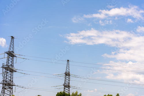 High voltage towers with sky background. Power line support with wires for electricity transmission. High voltage grid tower with wire cable at distribution station. Energy industry  energy saving