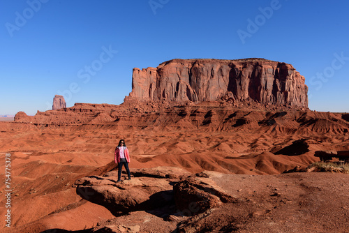 A tourist woman enjoys visiting Monument Valley. Travel in the winter in Arizona, USA