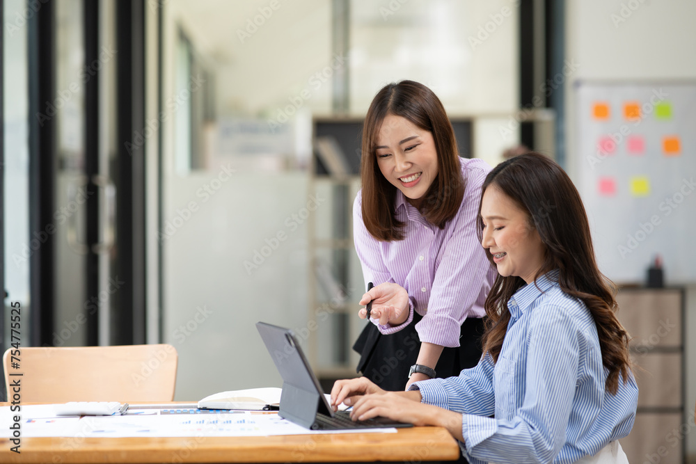 Asian business woman working and talking at the office
Asian business woman working and talking at the office