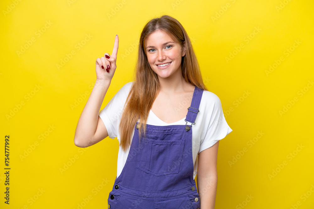 Young caucasian woman isolated on yellow background pointing up a great idea Young caucasian woman isolated on yellow background pointing up a great idea