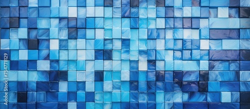 A blue tiled wall adorned with countless small squares in multiple shades, creating a striking mosaic pattern. The squares are neatly arranged in rows, giving the wall a modern and geometric
