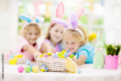 Kids on Easter egg hunt. Children dye eggs.