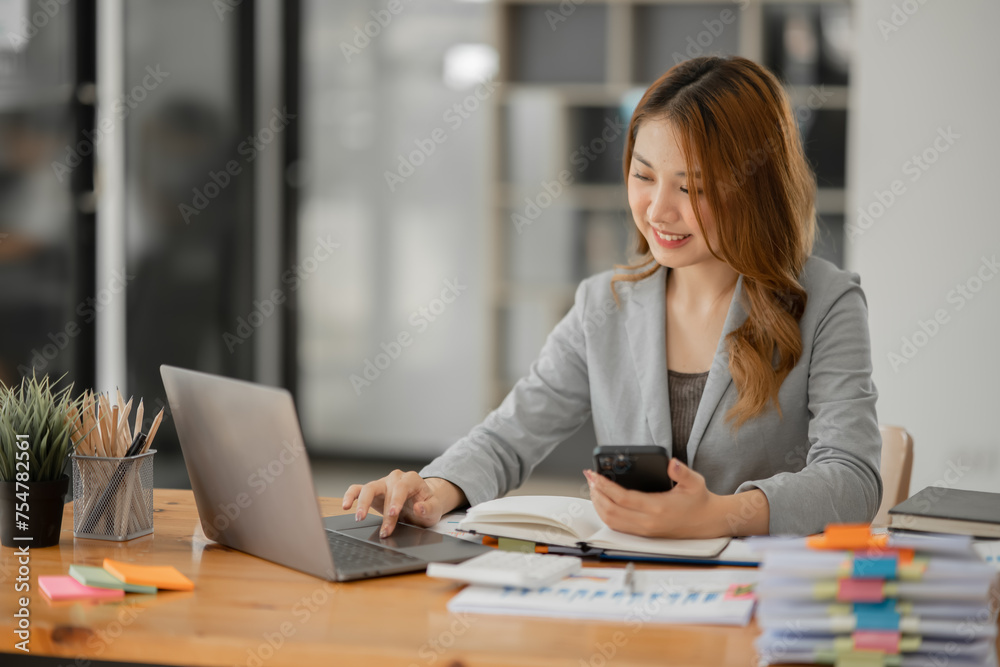 Asian business woman working and talking at the office 