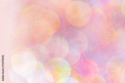 Pink peach color Defocused abstract bokeh background pastel hues, flare from lights, color gradient, blurred round bokeh as holiday texture. Glittering textured lighting pattern