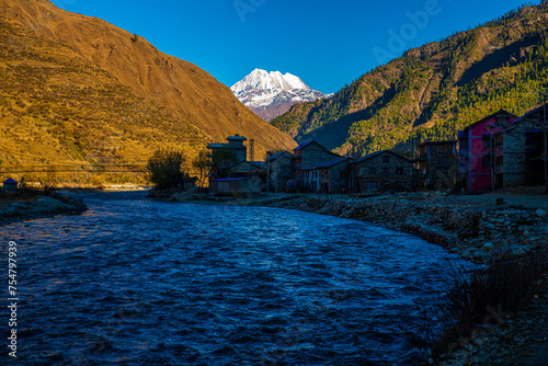 Snow-Capped Mountain Backdrop behind Chumchaur Jyulo Village, Jumla, Karnali Province, Nepal photo