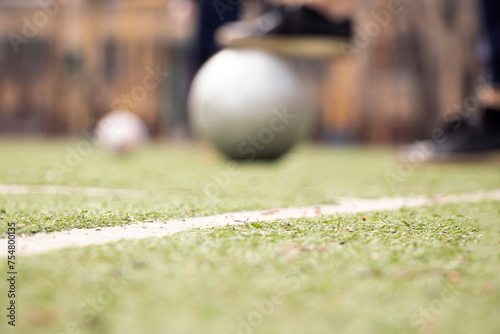 Female legs on a football field and a gray soccer ball in Ukraine,playing football in the yard