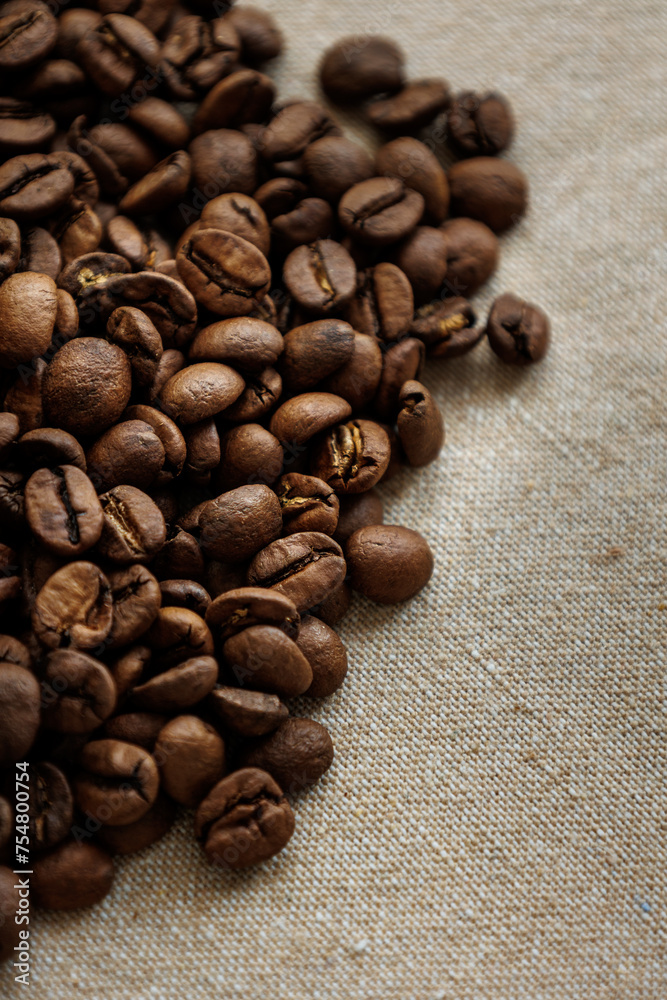coffee beans are on table after roasting. Fresh converted coffee beans before packing in paper bag. Ground coffee for making Americano or cappuccino. grain cultivation and harvesting coffee beans are on table after roasting. Fresh converted coffee beans before packing in paper bag. Ground coffee for making Americano or cappuccino. grain cultivation and harvesting