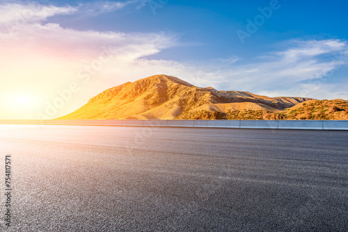 Asphalt highway road and mountain natural landscape at sunset