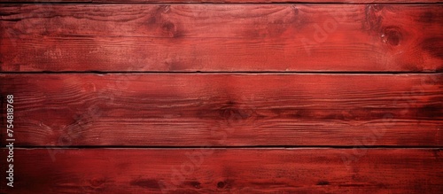 A detailed view of a weathered wooden surface painted with a vibrant shade of red. The solid and hard texture of the wood is evident, with visible scratches and a worn appearance.