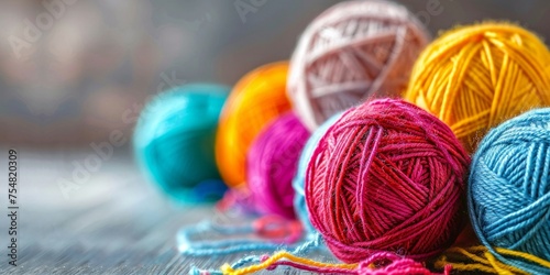 Colorful balls of yarn arranged on a rustic wooden surface with a soft-focus background.