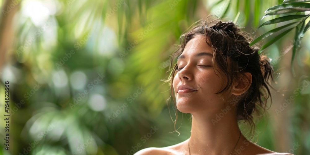 A peaceful young woman closes her eyes, surrounded by lush tropical foliage, embodying tranquility. A peaceful young woman closes her eyes, surrounded by lush tropical foliage, embodying tranquility.