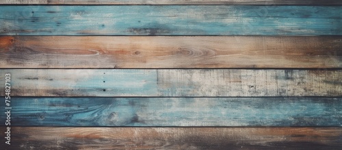 A wooden wall covered in a coat of blue paint, showing the texture of the wood underneath. The paint is a vibrant shade of blue, creating a bold and eye-catching visual contrast.