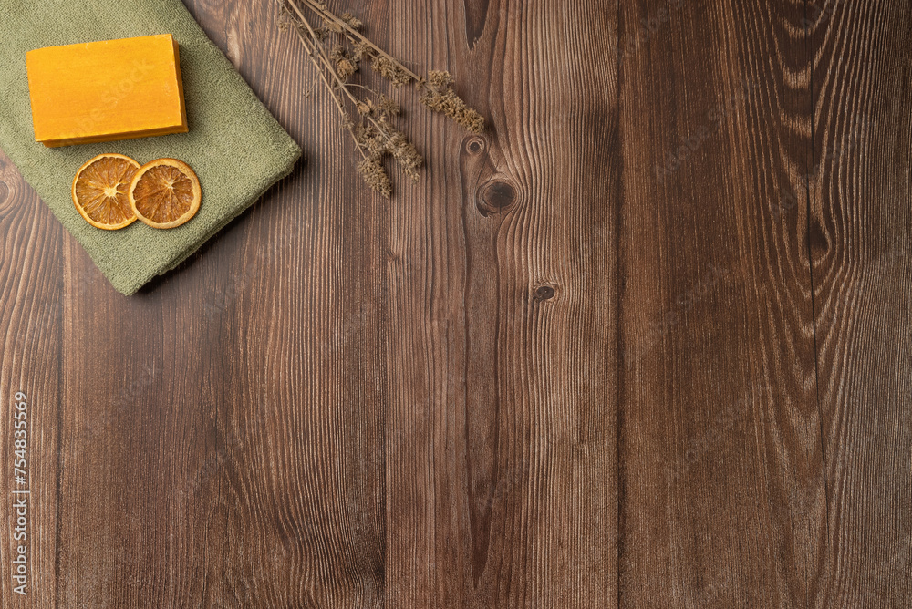 A piece of soap and dried lemon on a towel on a wooden background. Spa concept A piece of soap and dried lemon on a towel on a wooden background. Spa concept