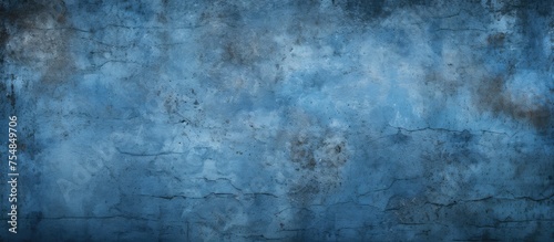 A weathered blue cement wall stands prominently against a deep black backdrop, creating a striking contrast in textures and colors. © TheWaterMeloonProjec
