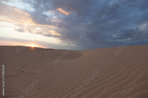 Sunset over the sand dunes in Sahara desert near Tozeur