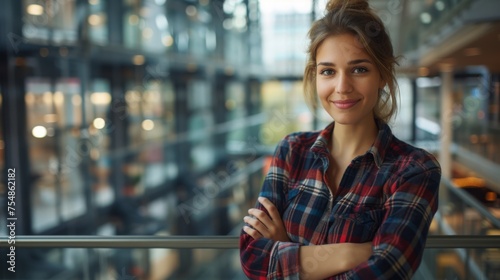 A multiracial woman standing with her arms crossed in front of a window photo