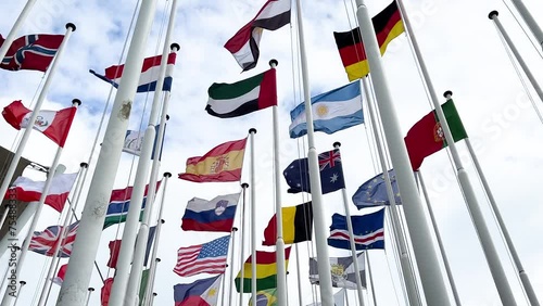 many flagpoles with country flags of different countries photo