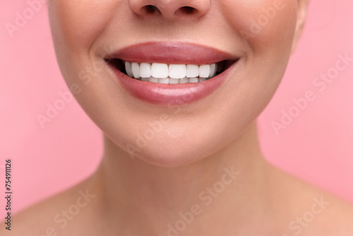 Woman with beautiful lips smiling on pink background  closeup