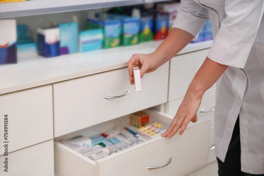 Professional pharmacist with medicine in drugstore, closeup Professional pharmacist with medicine in drugstore, closeup