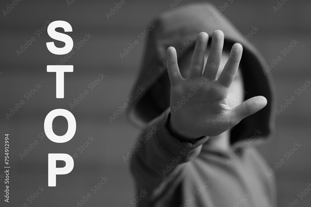 No child abuse. Boy making stop gesture, selective focus. Black and white effect No child abuse. Boy making stop gesture, selective focus. Black and white effect