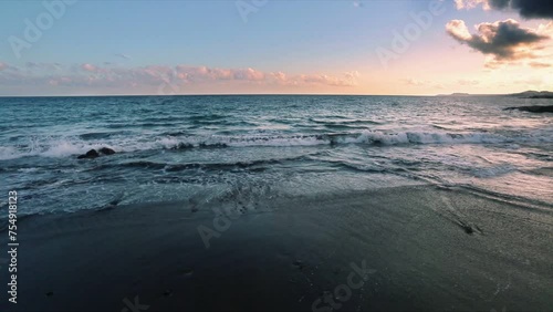 sea sunset at volcanic sand beach