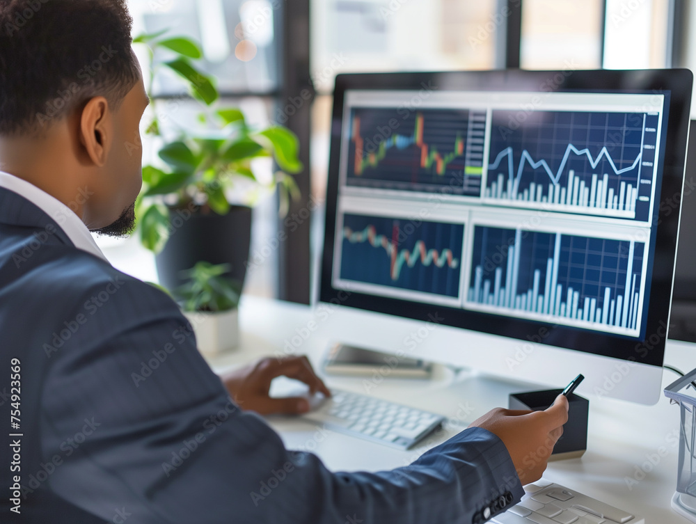 A businessman sits at a desk in front of a computer screen and analyzes charts and graphs. Analyzing price increases, profits, business performance. The concept of selling a real estate purchase. A businessman sits at a desk in front of a computer screen and analyzes charts and graphs. Analyzing price increases, profits, business performance. The concept of selling a real estate purchase.