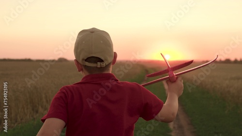 hands boy child kid airplane background setting sun. Child Kid runs across field embodying dream flying, Child Kid Runs through park toy airplane hands, childkid boy raised hand launching airplane