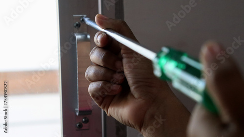 a woman screwing with a screwdriver