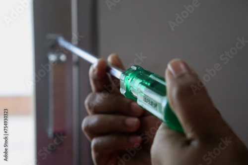 a woman screwing with a screwdriver