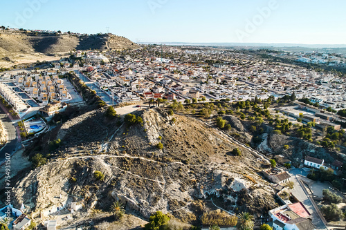 Aerial view of Rojales townscape with Monte Calvario and three crosses against blue sky view. Rojales, town, Spain
